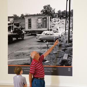 Auburn resident David Cooper showing his grandson a mural