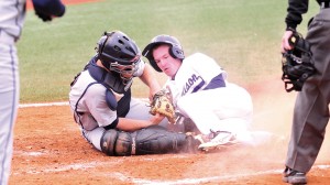 <p class="p1"><strong>Freshman third baseman Chad Carroll slides into home plate without earning a run in Tuesday’s game. Liberty scored twelve runs against the Dukes.</strong></p>

