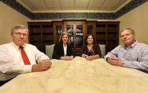 Ron Storey, Holly Sawyer, Ashton Ott and Pete McInish pose for a photo inside of a counference room at the Lewis, Brackin, Flowers, Johnson and Sawyer Law Firm on Monday.