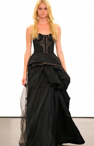 A model presents a black wedding dress design by Vera Wang