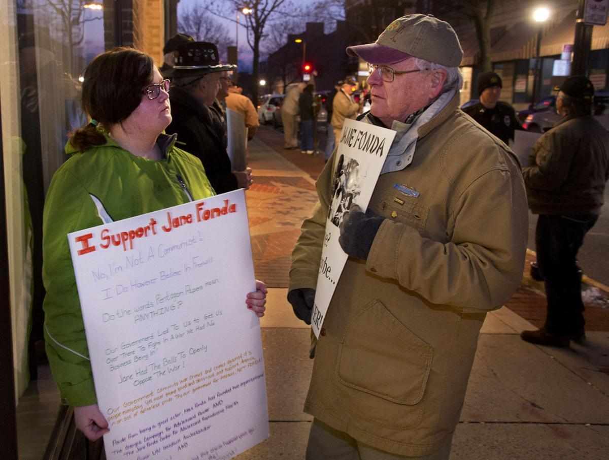 Demonstrators gather outside the theater