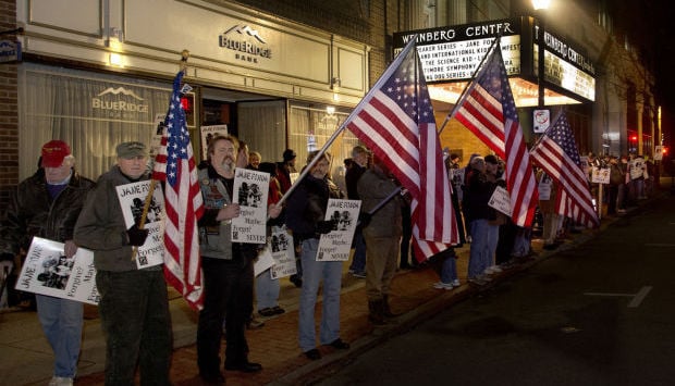 Demonstrators stand in protest of Fonda