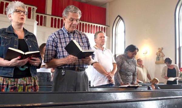 Congregants take part in Sunday Mass at St. John the Baptist Orthodox Church. Church goers say they were drawn to the tiny church in part for its ancient rituals and traditions. David Frey photo.