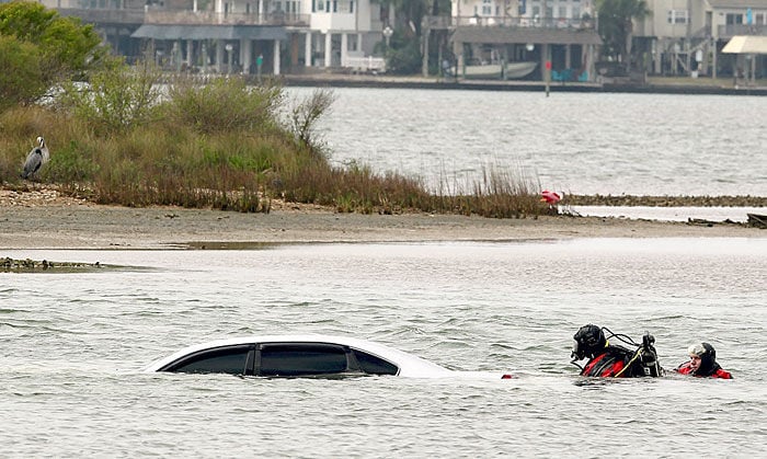 Two Galveston County Sheriff39;s Office divers search a submerged 