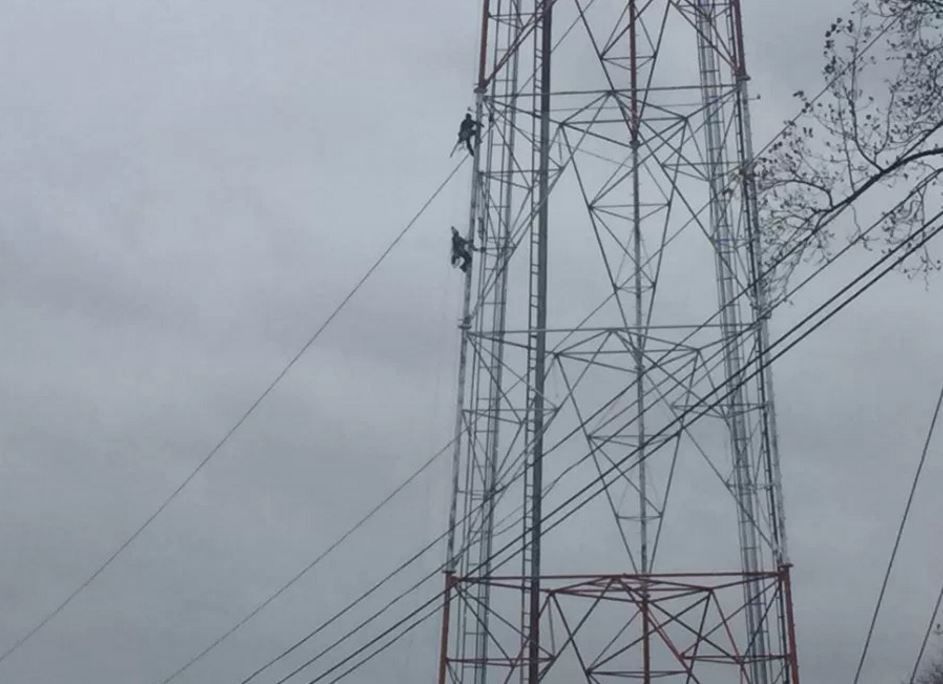 Workers remove body of man found hanging 400 feet up radio tower