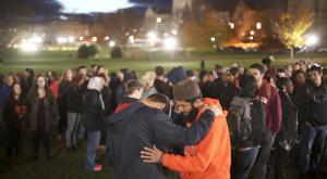 Mg Vt Muslim 111015: Payton Seay, left, of the Baptist Campus Ministry and Samee Khan of the Virginia Tech Muslim Students Association pray prior to the start of the rally on the Drillfield Tuesday. The Virginia Tech Muslim Students Association held a rally in the wake of a threat scrawled on a bathroom wall in Price Hall last week. - MATT GENTRY | The Roanoke Times