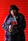 Felicia Vanderford holds a photo of her deceased son Dorcy Davis, eyes partially shut