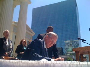 Gov. Jay Nixon signs the veto letter for a bill that would have made it easier for employers to avoid discrimination suits