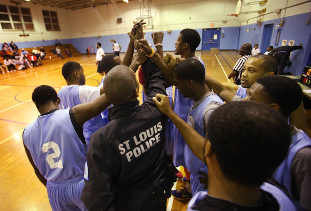 st louis police officer jeremy cotton coach of the thunder brings his team together for a cheer after a timeout during a s human services school age poverty