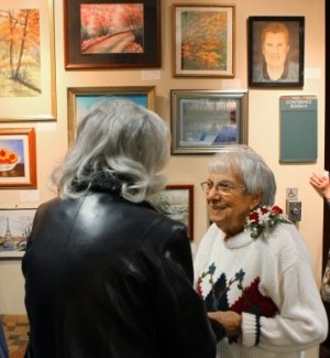 Artist Virginia R. Leitner greets visitors