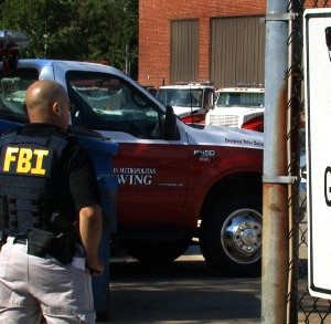 Metropolitan Towing lot entrance with FBI agents on duty 