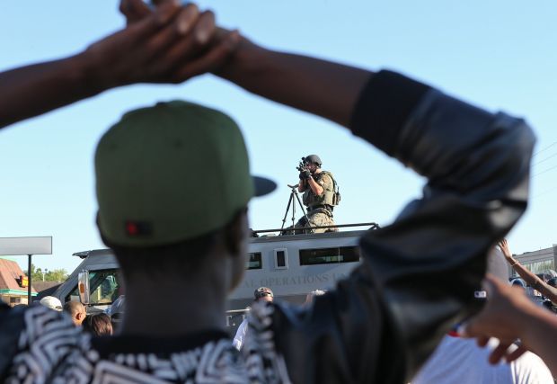 Sniper on top of tactical vehicle