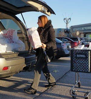 Shopper loads her car at St. Louis Mills in Hazelwood
