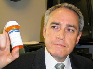 JIM MERKEL / JOURNAL Madison County State&#39;s Attorney Thomas D. Gibbons holds a prescription bottle. Gibbons and Madison County Coroner Steve Nonn are urging ... - 4f7f3759b5e17.preview-300