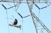 Workers use Helicopter to install 