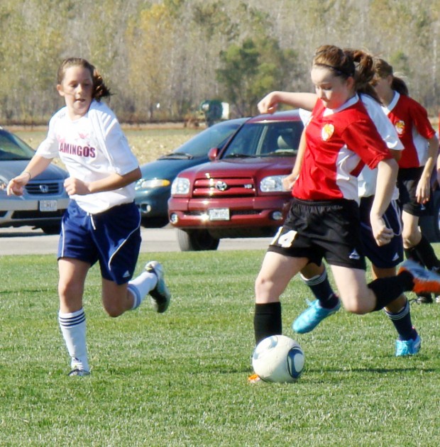 Pink Flamingos Magenta player Addison Caldwell, left, tries to
intercept Blast player Jordan Gamble as she moves the ball down the
field Saturday during the two independent teams' SLYSA game. The
Pink Flamingos Magenta edged the Blast 4-3. (Cathy Hensley |
STLclubsoccer.com)
