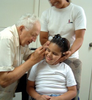 Bob Lammert checks a patient's ear