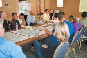<p>About 20 people attended the first stakeholder meeting to implement a State Recreational Trails planning grant to design a bike path over Hoosier Pass. Park County Commissioner Mark Dowaliby is seated on the top left side, Interim Park County Administration Officer Tom Eisenman is seated on the bottom left,  Summit County  Commissioner Thomas Davidson is fourth from the left (below the map) and Summit County Assistant Manager Thad Noll is sixth from the left (to the right of the flag). Others in attendance were Cory Kristzmire, an owner of Alma-based Al-Mart general store (not shown), Summit County’s state wildlife manager, one or more representatives from the Colorado Department of Transportation, Summit County Open Space and Trails Department Resource Specialist Starr Jamison (not shown), and representatives from Blue River Sanitation District and the towns of Blue River and Breckenridge. (Photo by Lynda James/The Flume)</p>
