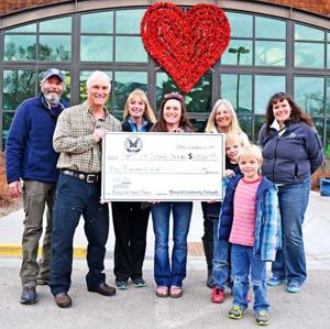 Monarch Community Outreach board members present a check to Friday Enrichment Program