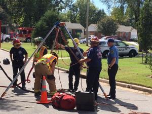 Firefighters search for person after manhole cover removed