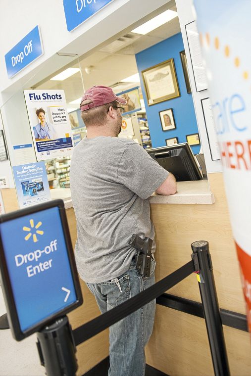 ... with the pharmacist at Wal-Mart. BRETT ROJO / For the Tulsa World