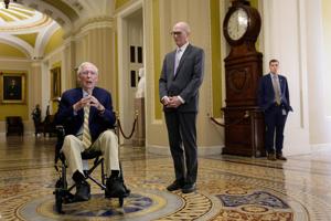 U.S. Senator Mitch McConnell speaks to reporters outside the Senate Chamber after returning to Capitol Hill in Washington