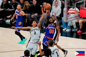 Jun 13, 2026; San Antonio, Texas, USA; New York Knicks guard Jordan Clarkson (00) makes a jump shot over San Antonio Spurs guard Dylan Harper (2) during the third quarter during game five of the 2026 NBA Finals at Frost Bank Center. Mandatory Credit: