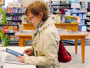 A customer examines a Nook e-reader at a bookstore in Boston.