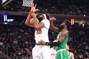 Apr 9, 2026; New York, New York, USA; New York Knicks center Mitchell Robinson (23) secures a rebound against Boston Celtics center Neemias Queta (88) during the first half at Madison Square Garden. Mandatory Credit: Lucas Boland-Imagn Images