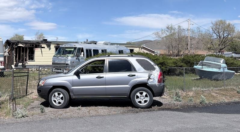 Cars near burnt out home on Ormsby Lane