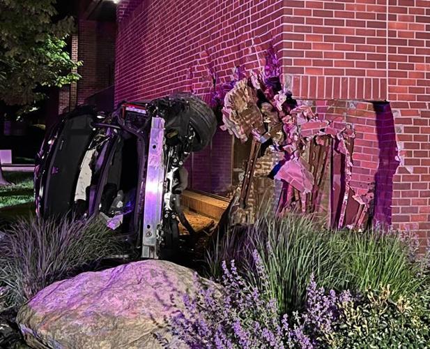 Rollover crash next to building