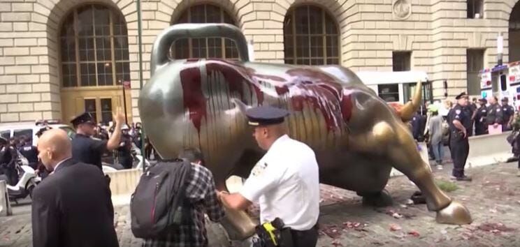 Climate Protesters Pour Fake Blood on Wall Street Bull Statue