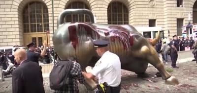 Climate Protesters Pour Fake Blood on Wall Street Bull Statue