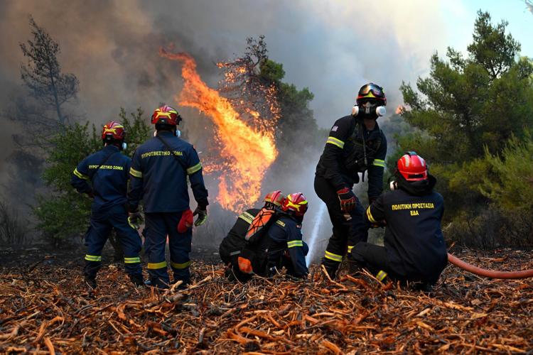 Photos show destruction from wildfires in Greece as blazes take hold in Europe and parts of the US
