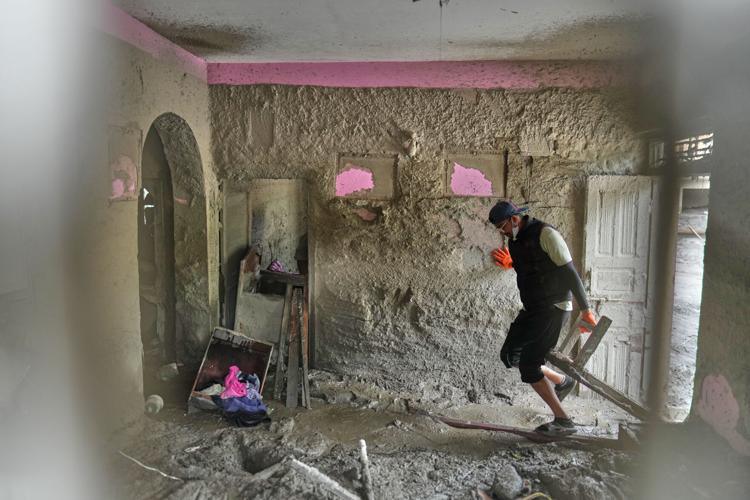 People salvage their belongings from homes and schools after flooding in Nepal and Tibet, in photos
