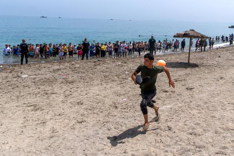 Migrants cross into Spain’s Ceuta enclave from Morocco, in photos