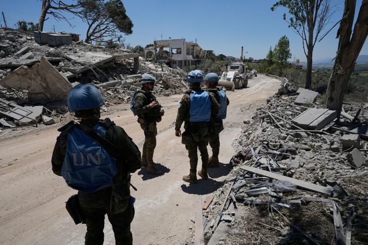 Photos show Lebanese and UN troops take positions in a village vacated by Israeli soldiers