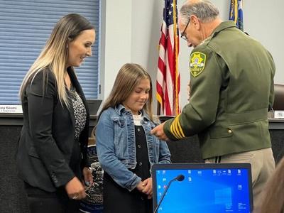 Ashley and Avery Meznarich look down at the awards from Sheriff Ken Furlong (002).jpg