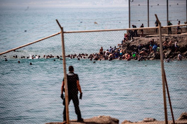 Migrants cross into Spain’s Ceuta enclave from Morocco, in photos
