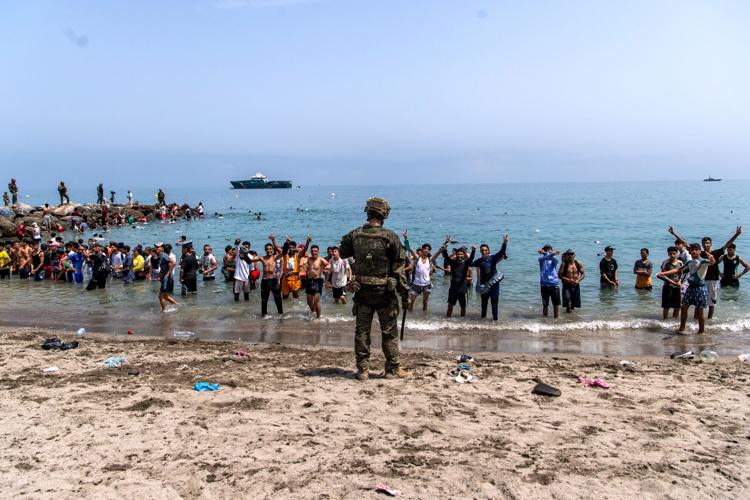 Migrants cross into Spain’s Ceuta enclave from Morocco, in photos
