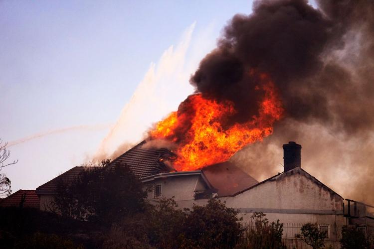 Photos show wildfire fueled by high winds engulfing coastal homes in Southern California