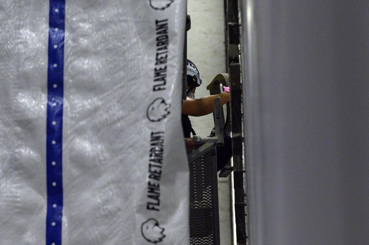 Workers prepare to remove Trump's name from the Kennedy Center, in photos
