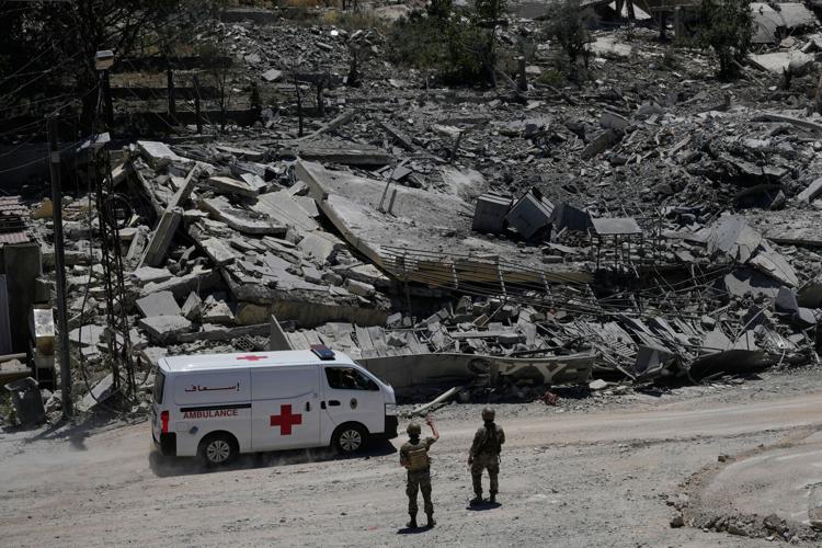 Photos show Lebanese and UN troops take positions in a village vacated by Israeli soldiers