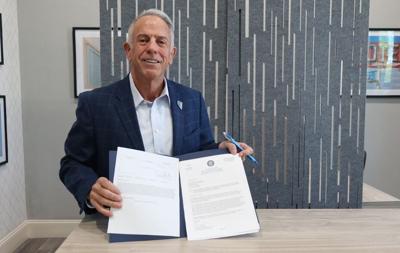 Governor Lombardo signs paperwork
