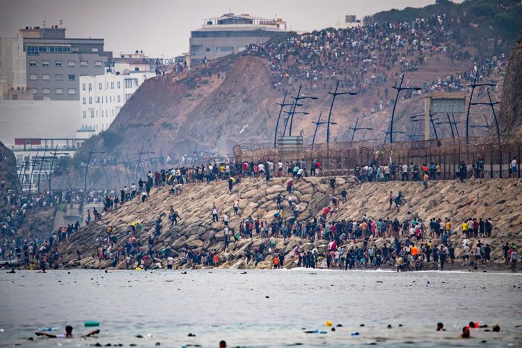 Migrants cross into Spain’s Ceuta enclave from Morocco, in photos