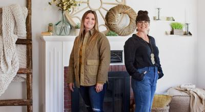 Leslie Davis, left, and her twin sister Lyndsay Lamb, right, pose in living room of a house they remodeled in Snohomish, Washington as seen on “Unsellable Houses.” Courtesy of HGTV.
