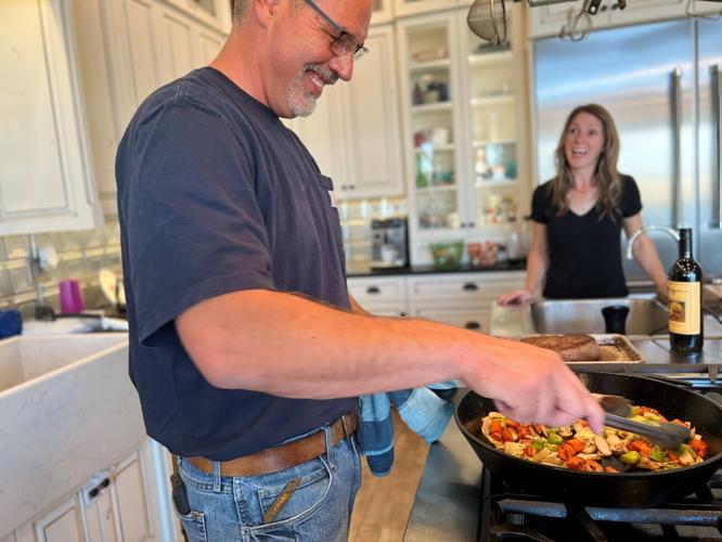 Dan Thiessen cooking in his kitchen with Melissa.jpg