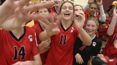 Bobcats' volleyball team celebrating win against rival Davison