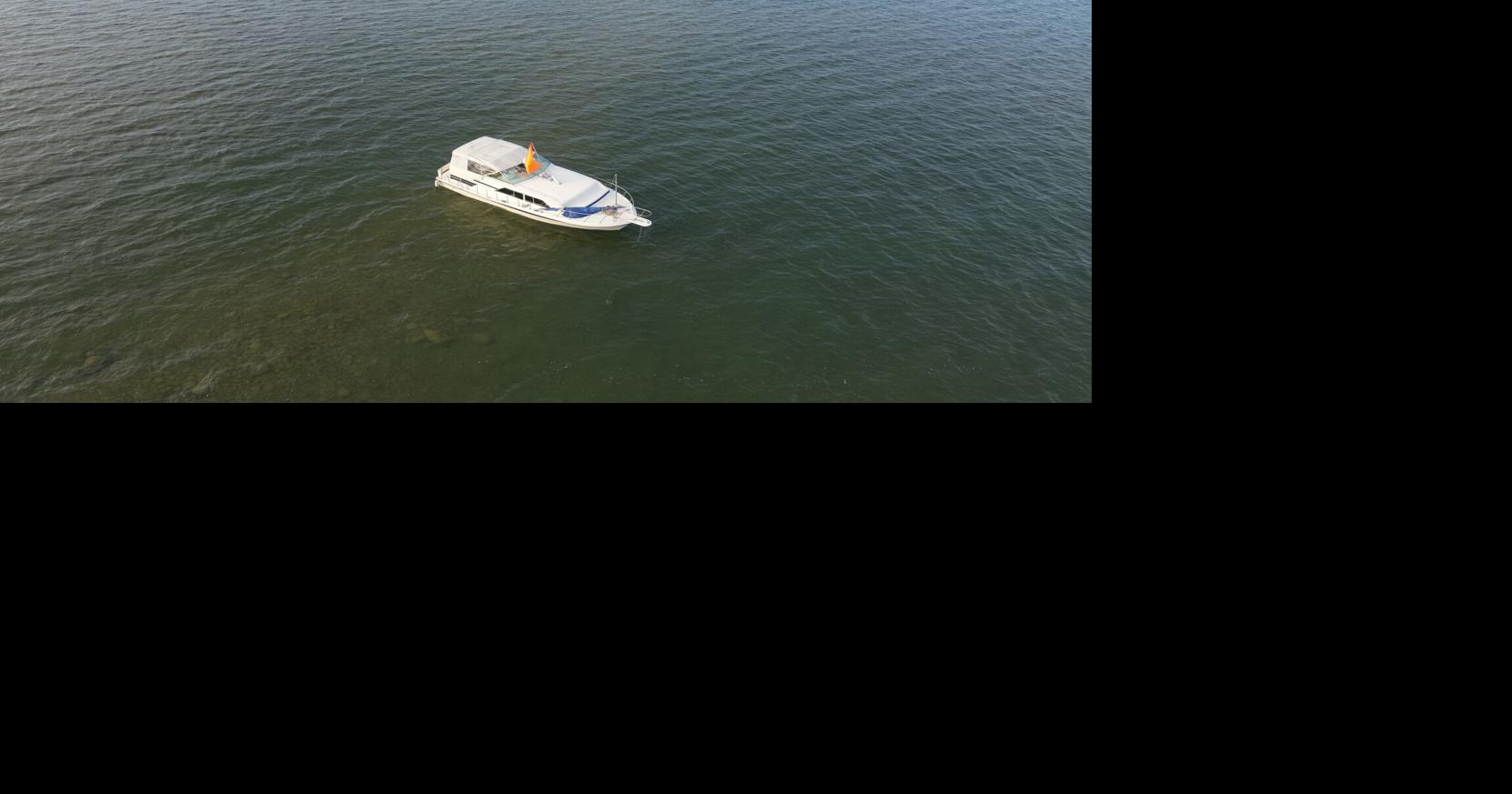 Woman and her two kids rescued after her boat runs aground in Lake ...