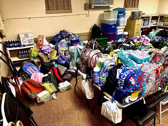 Hundreds of donated backpacks given to school children